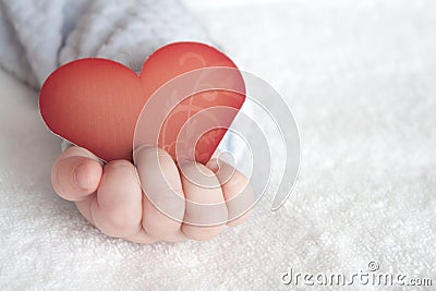 Heart shaped card in baby hand Stock Photo