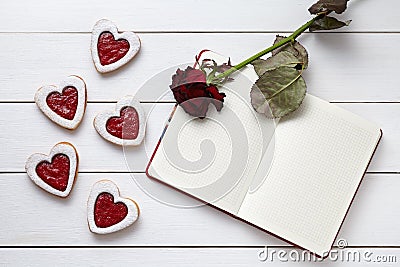 Heart shaped cookies with empty notebook frame and red rose gift composition for Valentines Day Stock Photo