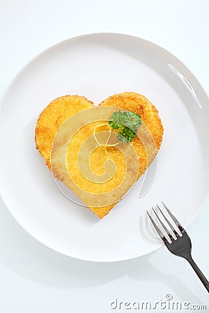 Heart shaped escalope of veal in breadcrumbs Stock Photo