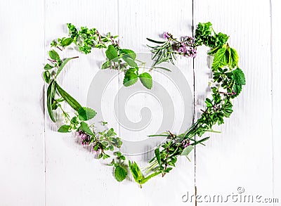 Heart shaped frame of fresh culinary herbs Stock Photo