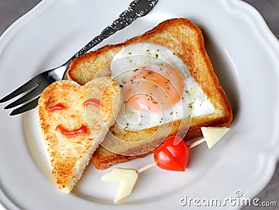 Heart-shaped fried egg and toast Stock Photo