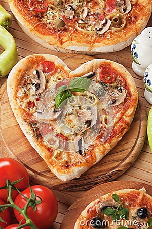 Heart shaped funghi pizza Stock Photo