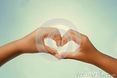 Heart shaped hands with noon sun and sky instagram Stock Photo