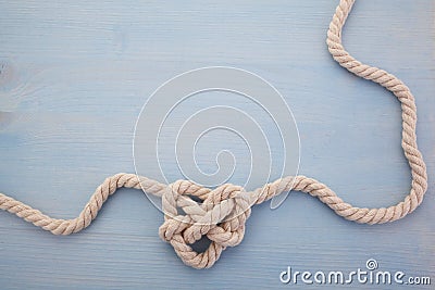 Heart shaped knot on blue wooden background Stock Photo