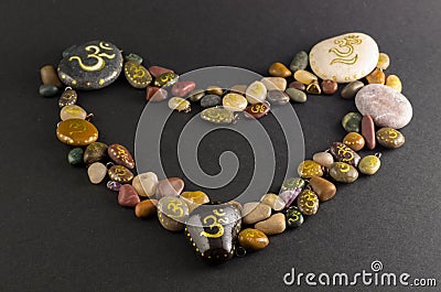 Heart shaped pile of decorative stones painted with Om symbol Stock Photo