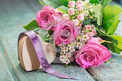 Heart-shaped present with a bunch of roses Stock Photo