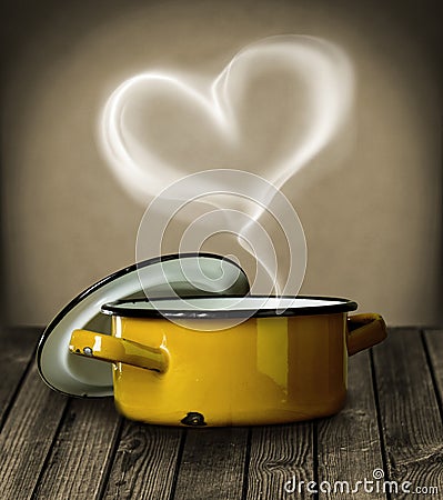 Heart shaped steam above a yellow pot Stock Photo