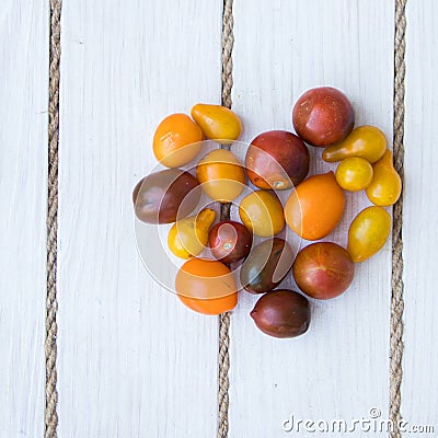 Heart shaped tomatoes. white wood background. soft focus. top view Stock Photo