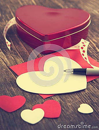 Heart shaped Valentines Day gift box and empty greeting card on wooden 