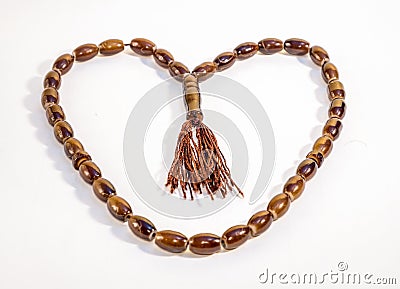 Heart Shaped Wooden Capsule Beeds of Tasbeeh against white background Stock Photo