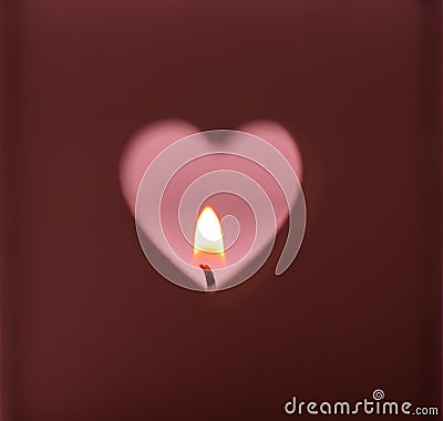Heart shapes hole cut out on dark red background burning candle light on pink backdrop, romantic, meditation Stock Photo