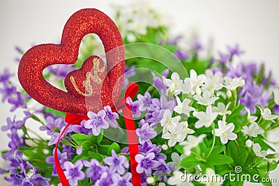 Heart, symbol of love in a bouquet small flowers. Stock Photo