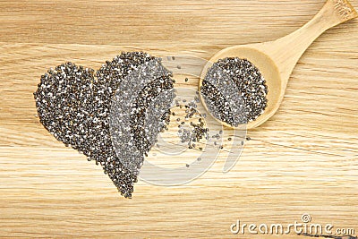 Heart symbol made of black chia seeds and spoon Stock Photo