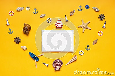 Heart symbol made of decorative items and miniature toys: seashells, seastar, vessel, life buoys, steering wheels, lighthouses. Stock Photo