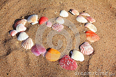 Heart symbol from shells on sand Stock Photo