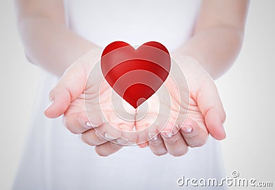 Heart on woman hands over body Stock Photo