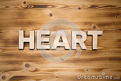 HEART word made with building blocks on wooden board Stock Photo