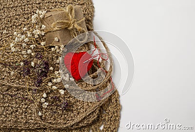 Heart of yarn in cloth and dried flowerson on white background Stock Photo