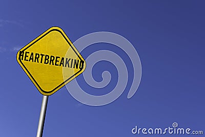 Heartbreaking - yellow sign with blue sky background Stock Photo