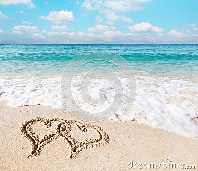 Hearts drawn on the beach sand. Stock Photo