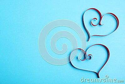 Hearts made of paper strips on color background, top view. Stock Photo