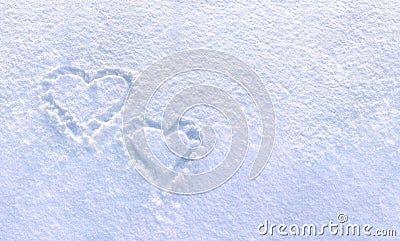 Hearts written on the fresh white blue snow surface in winter Stock Photo