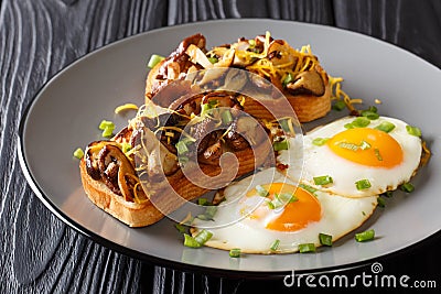 Hearty breakfast of fried toast with shiitake mushrooms and cheddar cheese served with eggs close-up on a plate. horizontal Stock Photo