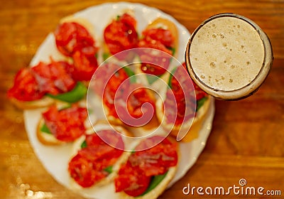 Hearty snack with different kinds of spreads on farmhouse bread served with a fresh yeast wheat beer Stock Photo