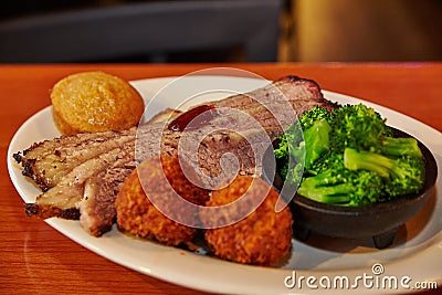 Hearty Southern BBQ Feast with Brisket and Hushpuppies in Restaurant Setting Stock Photo
