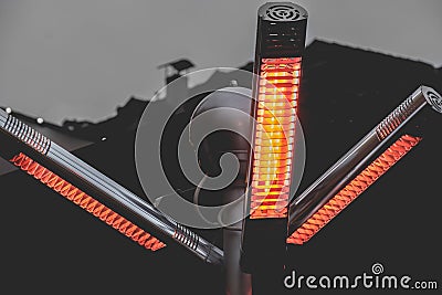 Heat infrared lamp gas patio heaters with propane in a warm light pole on street Stock Photo