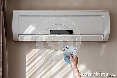 Heat pump and money. Heating price inflation, expensive heating and electricity Stock Photo