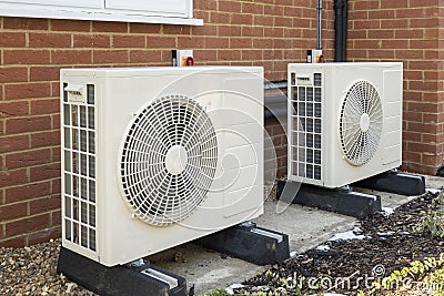 Heat pumps installed on the outside of a modern house Stock Photo
