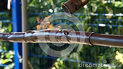 Heat shrink tubing for wires isolation in front of blue fence on green trees background. Frame. Wires protection process Stock Photo