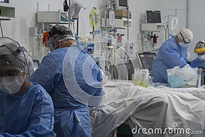 Heath Workers Inside COVID-19 ICU Editorial Stock Photo