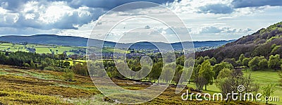 Heathland merges into a landscape of trees towards the town of Glossop, UK Stock Photo