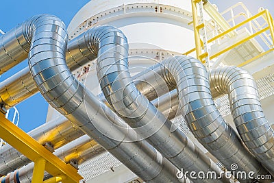 Heating medium oil pipeline protected with stainless steel insulation for keep temperature form environment. Stock Photo