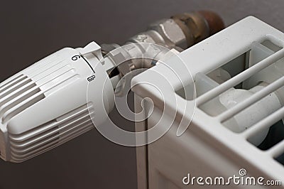 Heating controler on a white radiator. Stock Photo