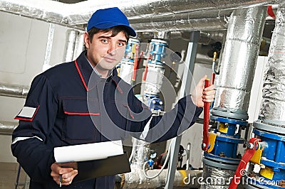 Heating engineer repairman in boiler room Stock Photo