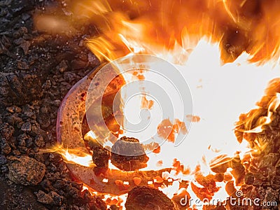 Heating of horse hooves in small forge Stock Photo