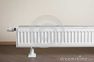 Heating radiator with thermostatic knob in the living room Stock Photo