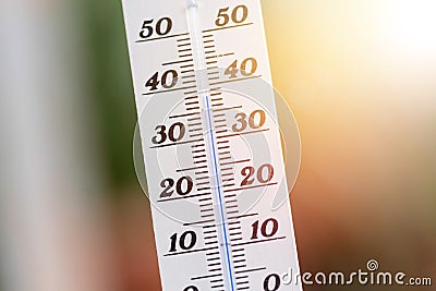 Heatwave: Thermometer in summer on a blurry background, heat Stock Photo