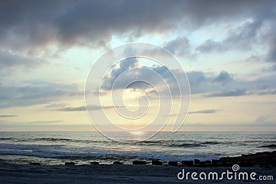 Heavenly Summer Sunrise Over Wooden Pier on the Beach Stock Photo