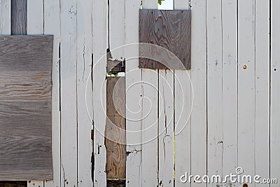 Heavily repaired wooden fence Stock Photo