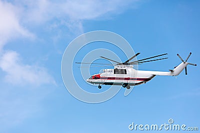 Heavy cargo helicopter flying against sky Stock Photo