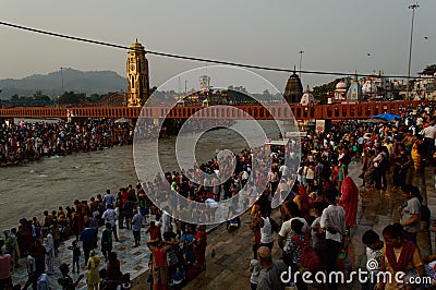 Heavy crowd going to take bath into ganga river due to saavan festival at haridwar bridge temple sky Editorial Stock Photo