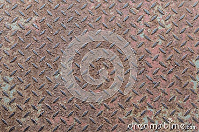 Heavy duty rusty metal with non slip repetitive patten and corroded vintage industrial steel plate structure as a retro grunge ba Stock Photo