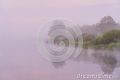 Heavy fog on the river. Trees are visible through thick fog Stock Photo