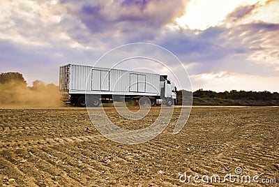 Heavy Goods in Transit via Dirt Roads - Rear View Stock Photo