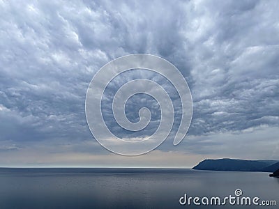 Heavy gray clouds over Baikal Lake, Russia Stock Photo