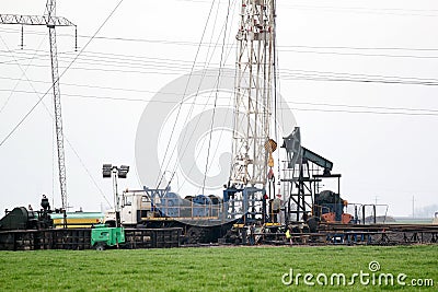 Oilfield with rig and pump jack Stock Photo